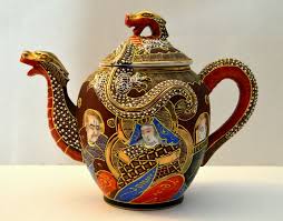 Ornate teapot with dragon and phoenix designs in vibrant colors.