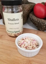 Dried shallots in a small white dish with a jar labeled 'Shallots Freeze Dried'.
