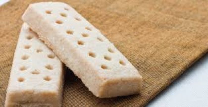 Shortbread cookies arranged on a brown cloth.