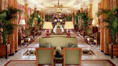 Elegant, lavishly decorated hotel lobby with classical furnishings and warm lighting.