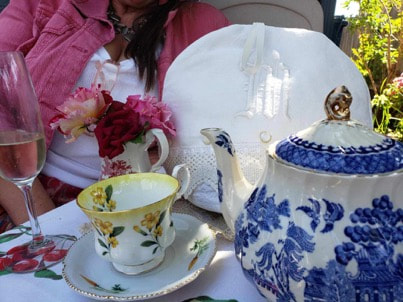 Elegant tea set with floral designs on a table.