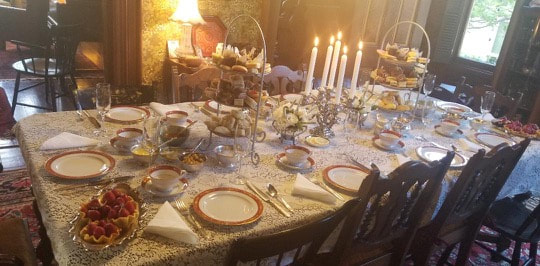 Elegant dining table set with candles and fine china.