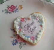 Heart-shaped cookie with 'Thank You' icing decoration.