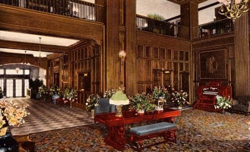 Elegant hotel lobby with floral arrangements and classic decor.