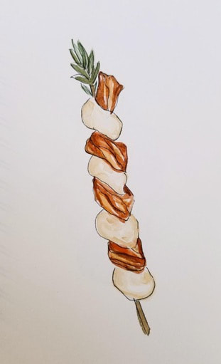 A skewer with alternating pieces of grilled meat and onions.