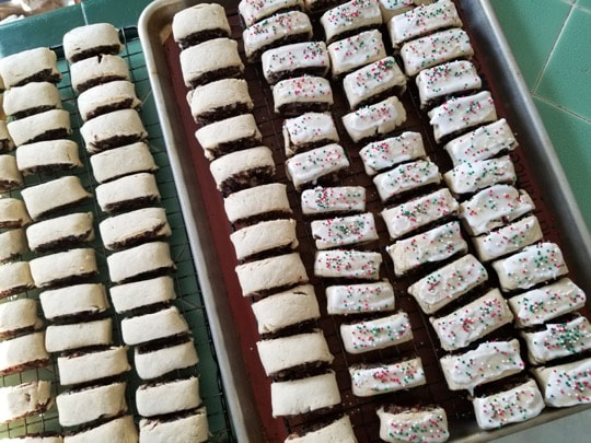 Rows of freshly baked cookies with colorful sprinkles.