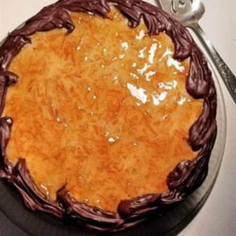 A round pie with a golden crust and chocolate frosting border.