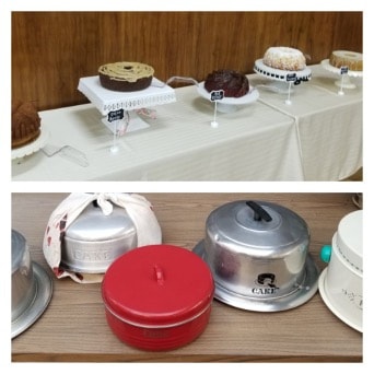 A table displaying various cakes and covered desserts in different containers.