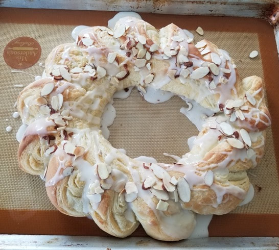 Braided bread wreath topped with sliced almonds.