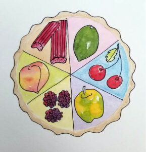 A round cookie decorated with colorful fruit and clothing illustrations.
