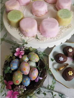Easter-themed treats including colorful eggs, marshmallow chicks, and decorated cookies.