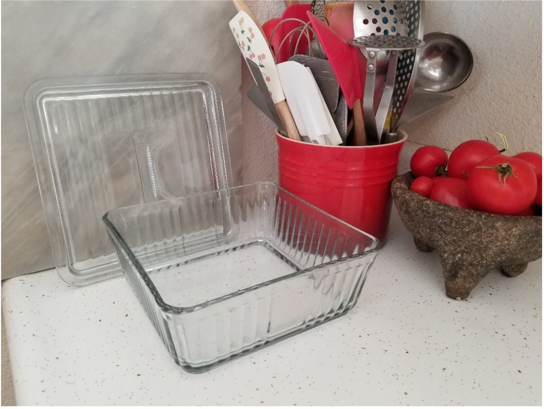 A clear rectangular glass baking dish on a kitchen counter.