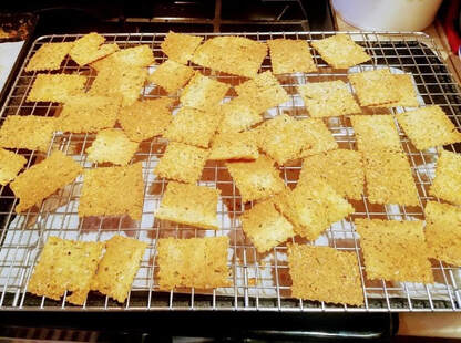 Golden baked crackers cooling on a wire rack.