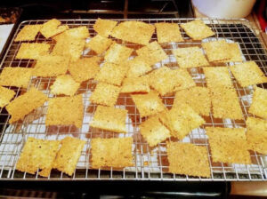 Golden crispy crackers cooling on a wire rack.
