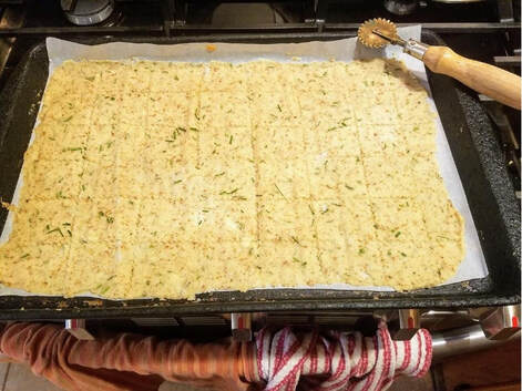 Baked herb and cheese flatbread on a tray.