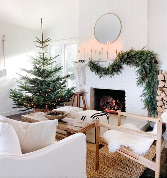 Cozy living room with a decorated Christmas tree and fireplace.