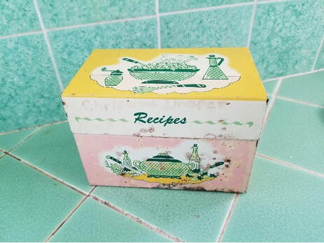 Vintage recipe box with kitchen illustrations and pastel colors.