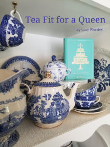 Blue and white porcelain tea set with a book, elegant tea setup.