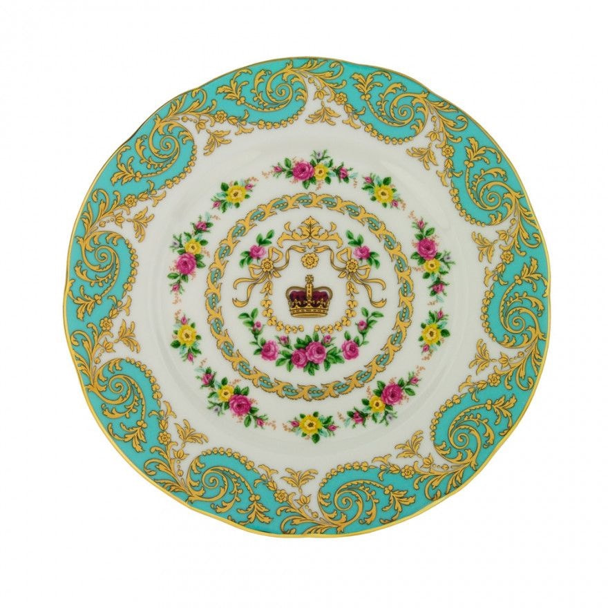 Ornate decorative plate with gold and floral designs on turquoise and white.