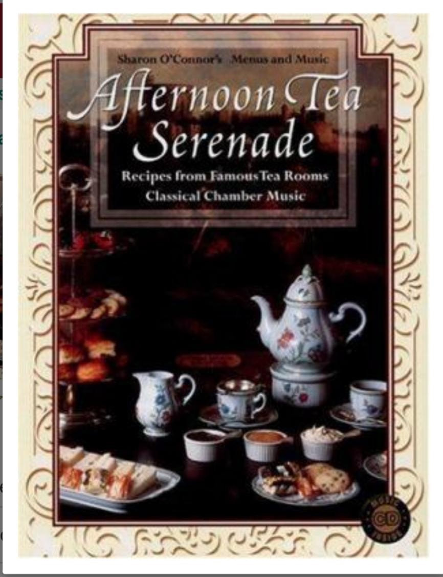 Vintage tea set with pastries on a table, evoking a classic afternoon tea.