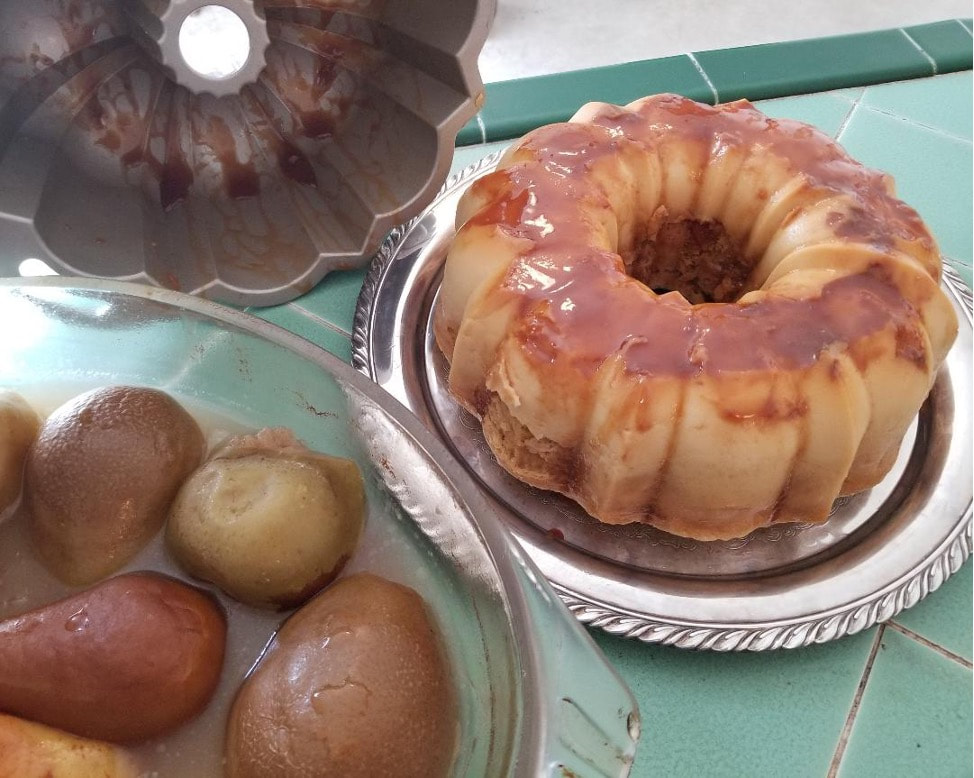 A glazed bundt cake and caramel-covered round treats on plates.