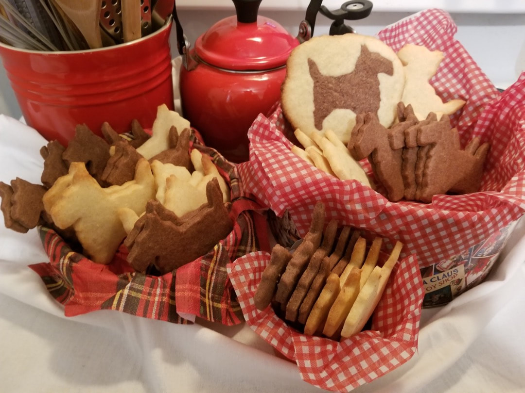 Assorted baked goods displayed in baskets with red and white checkered cloths.