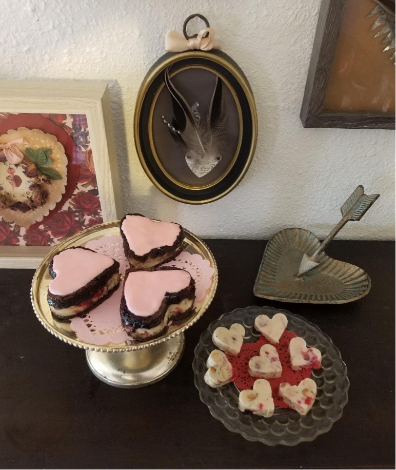 A variety of heart-shaped desserts on display at a cozy setting.