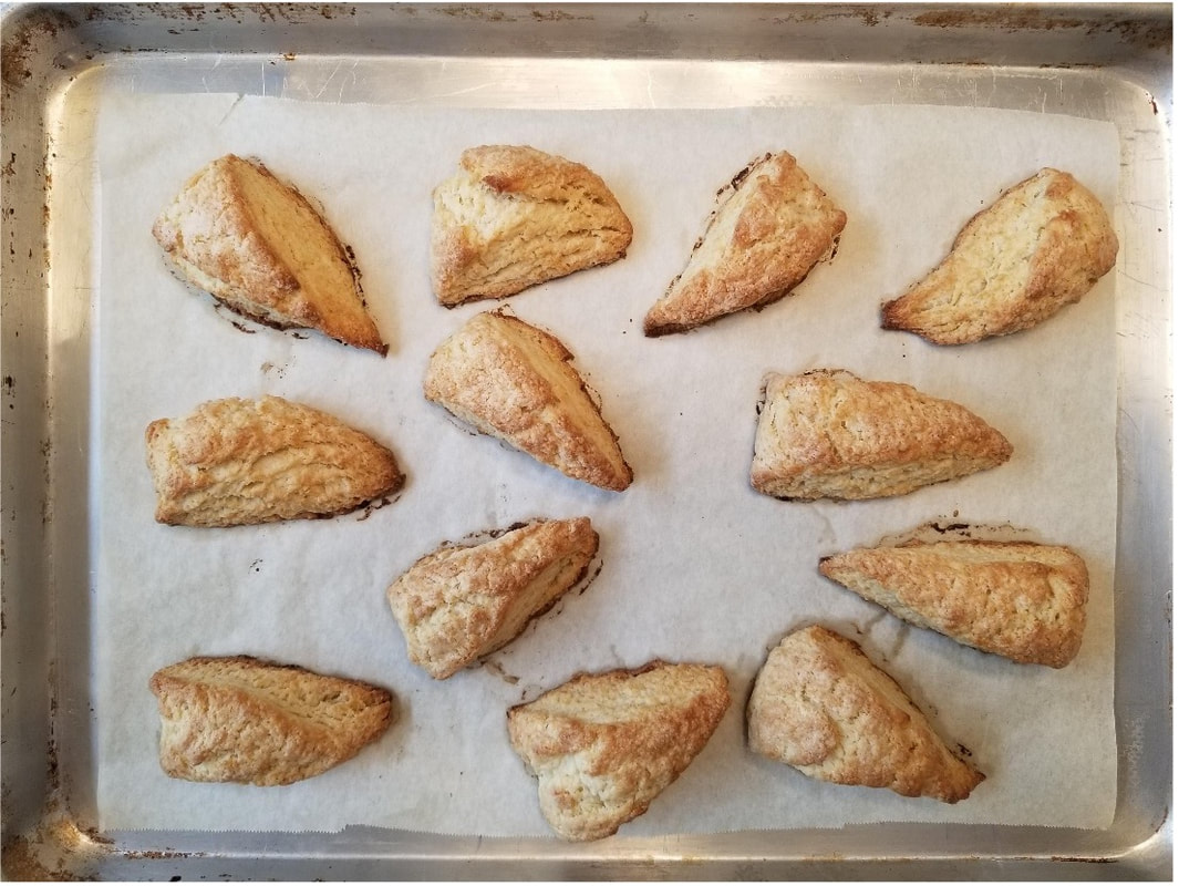 Freshly baked turnover pastries arranged on parchment paper.