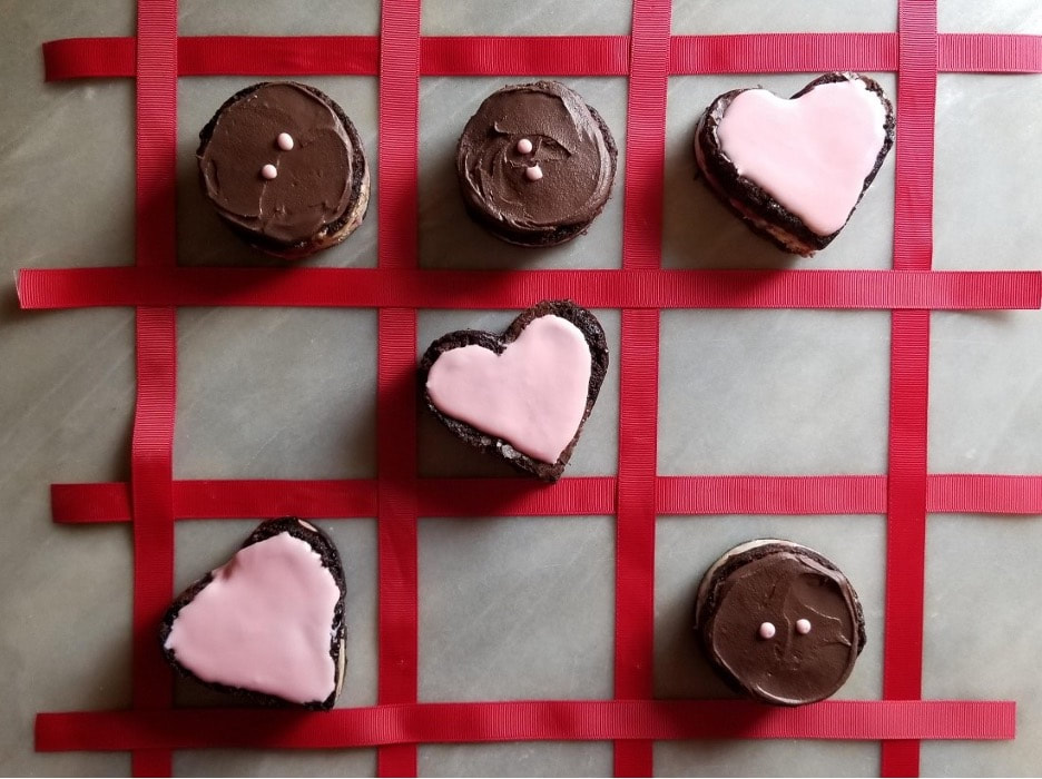 Delicious heart and bird-shaped cookies on elegant plates.