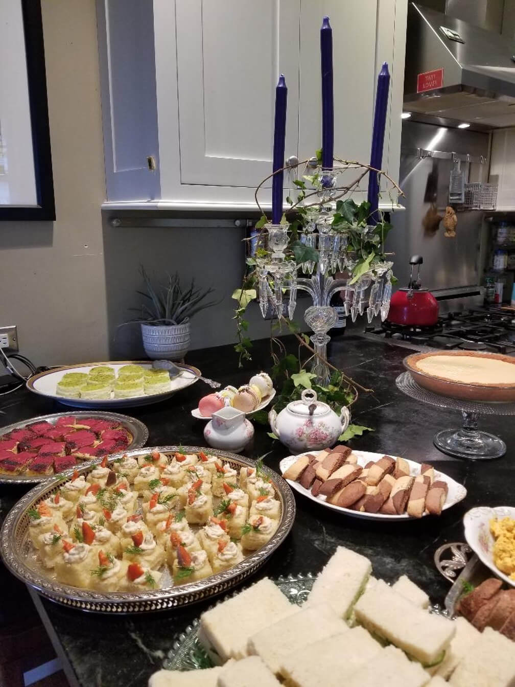 A table set with various dishes and a decorative candelabra centerpiece.