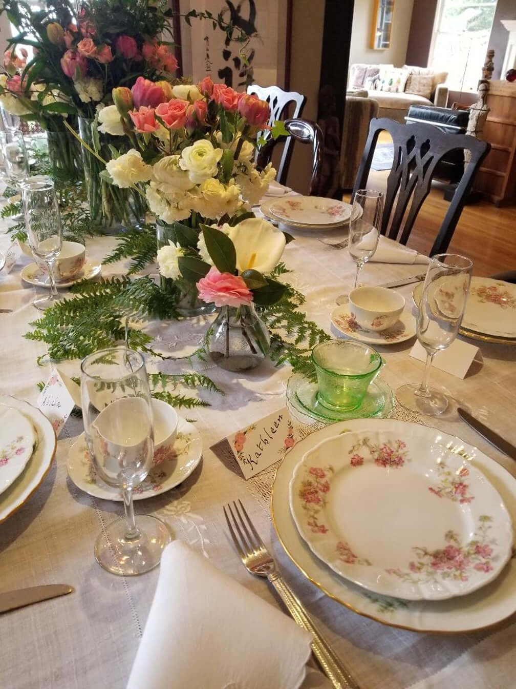 Elegant table setting with floral centerpiece and vintage china.