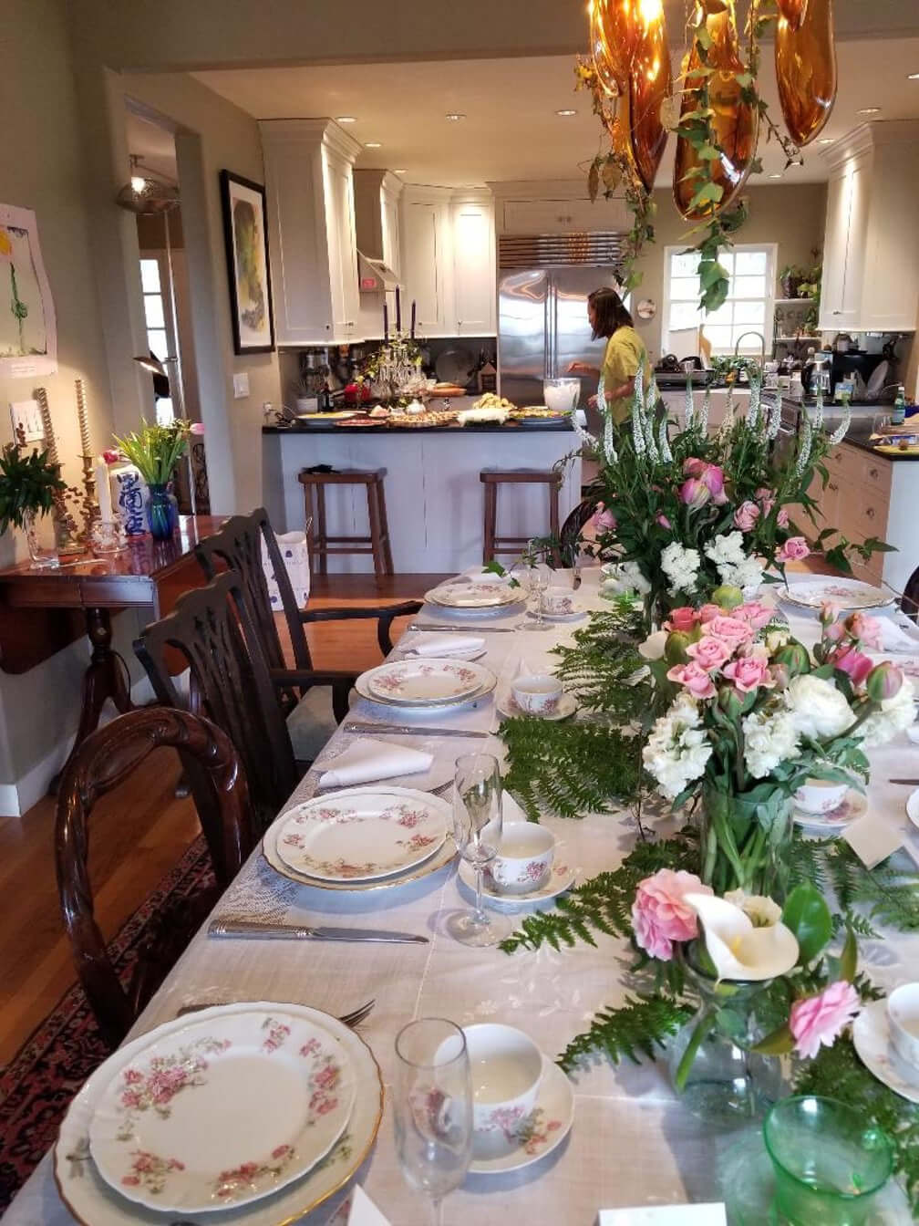 Elegantly set dining table with floral centerpiece in a cozy home.