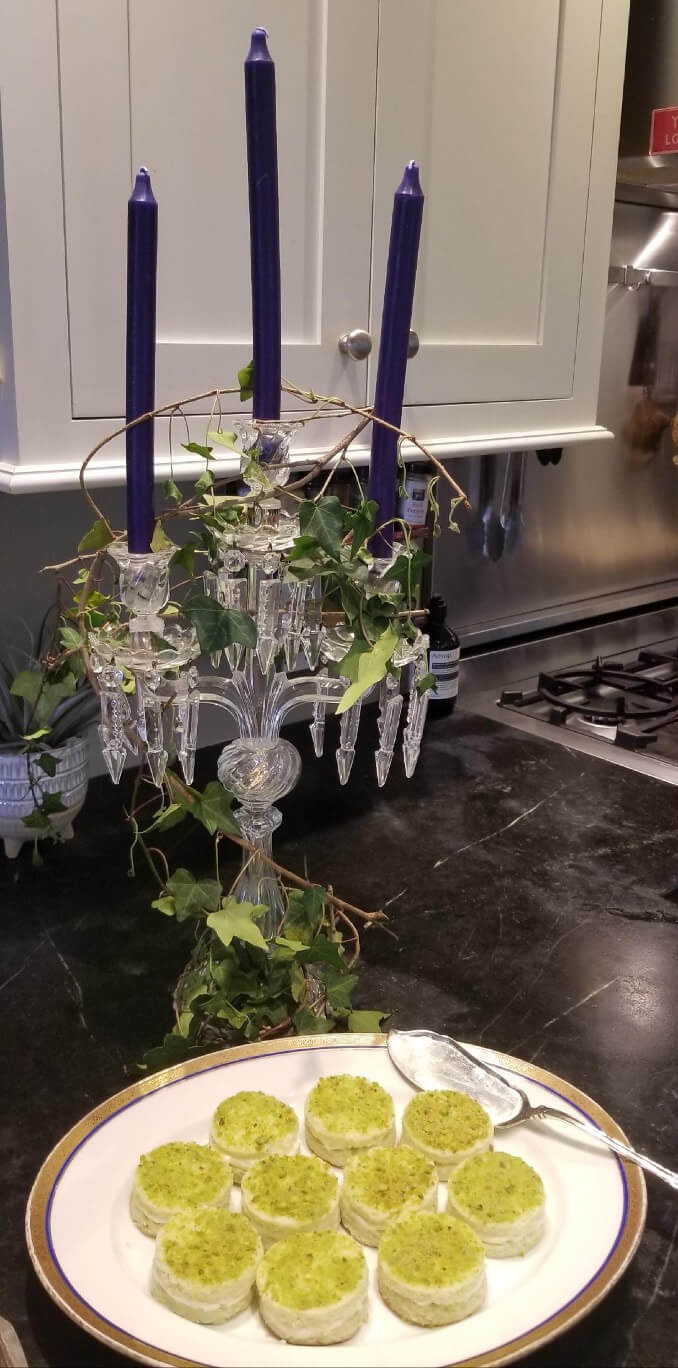 Elegant chandelier adorned with green ivy hanging in a modern kitchen.