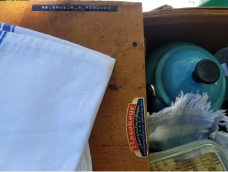 Close-up of a vintage Singer sewing machine with fabric and sewing supplies.