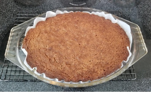 A freshly baked pie with a golden-brown crust in a baking dish.