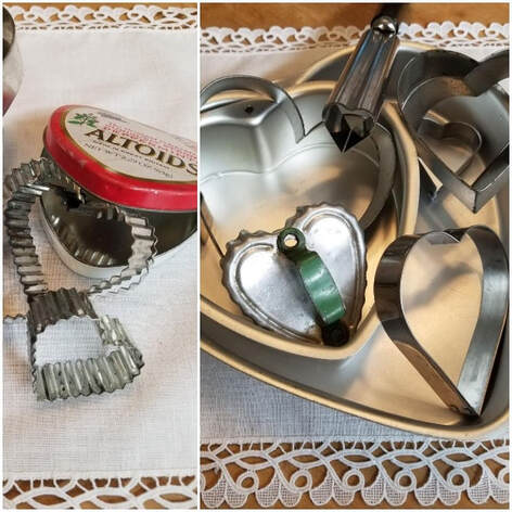 Vintage heart-shaped cookie cutters and a metal ricer on lace.