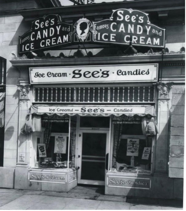 Historic black-and-white photo of See's Candy and Ice Cream shop storefront.