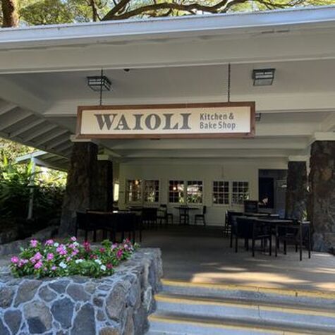 Entrance to Waioli Huiia Church with welcoming flowers and seating area.