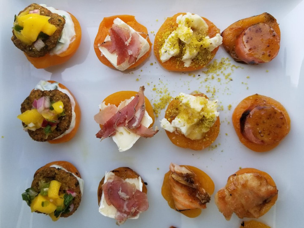 Assorted gourmet mini toasts topped with various savory ingredients.