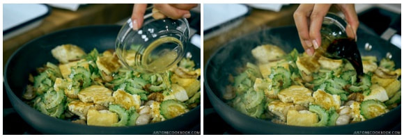 Pouring sauce over cooked Brussels sprouts in a pan.