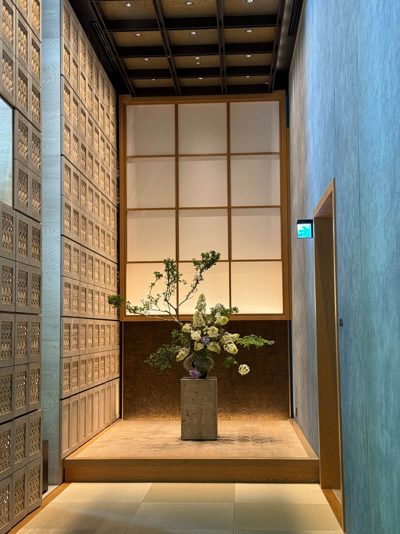 Minimalist flower arrangement in a serene, softly lit space.