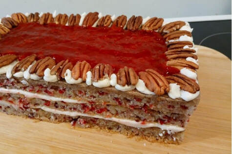 A pecan and caramel layered dessert topped with whole pecans.
