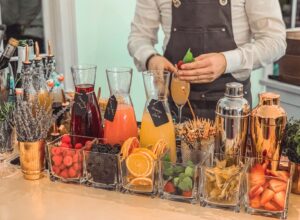 Colorful cocktail ingredients and garnishes on a bar counter.