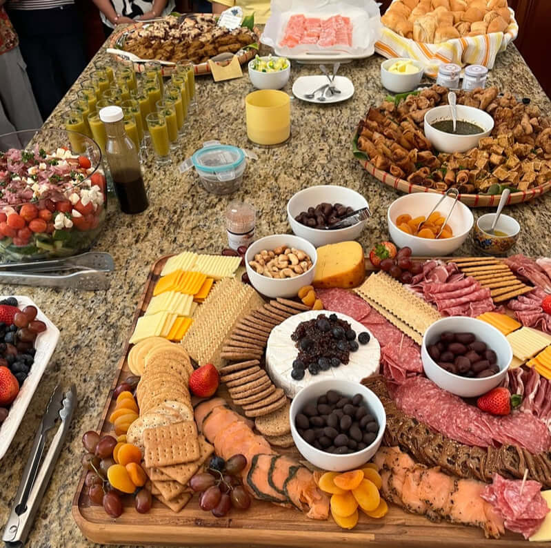 A vibrant charcuterie board with cheeses, meats, nuts, and dips.