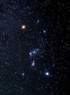 Bright stars scattered across a night sky with a prominent constellation.