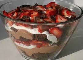 Layered chocolate and strawberry dessert in a glass bowl.