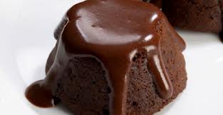 A close-up of a rich chocolate lava cake with melting chocolate on top.