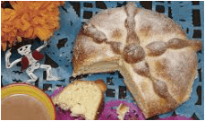 Traditional sweet bread with a slice cut out, placed on colorful paper.