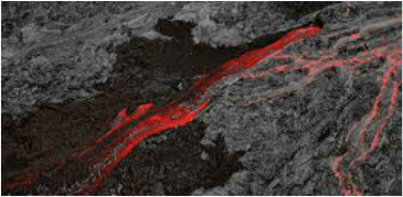 Molten lava flowing through dark volcanic rock.