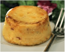 A golden-brown baked custard dessert on a plate.